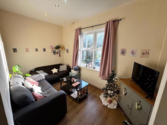 Bright, cosy living room with two comfortable s...