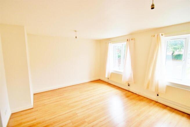 A bright and airy living room with large window...