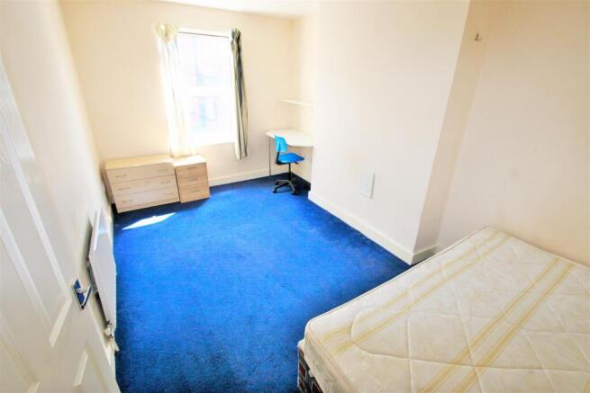 Bright and simple student bedroom featuring a s...