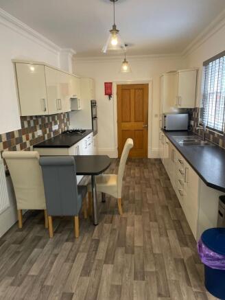Bright modern galley kitchen with long worktops...