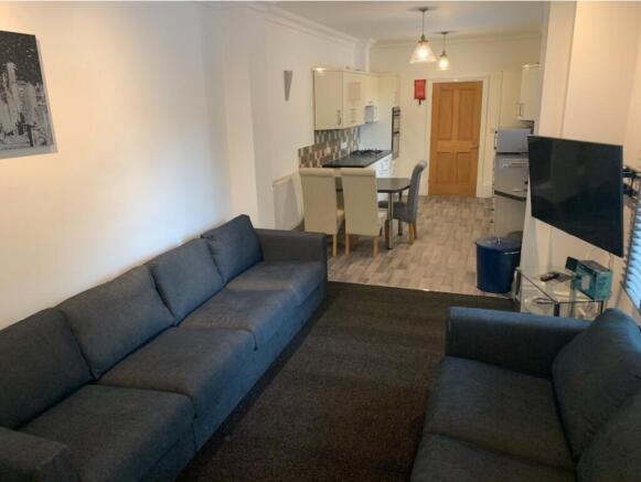 Contemporary open-plan living area leading to a...