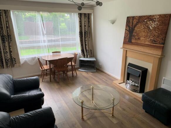 A bright and inviting living room featuring a l...