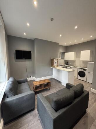 Modern and stylish living room featuring a comf...