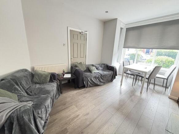 A spacious, naturally well-lit living room with...