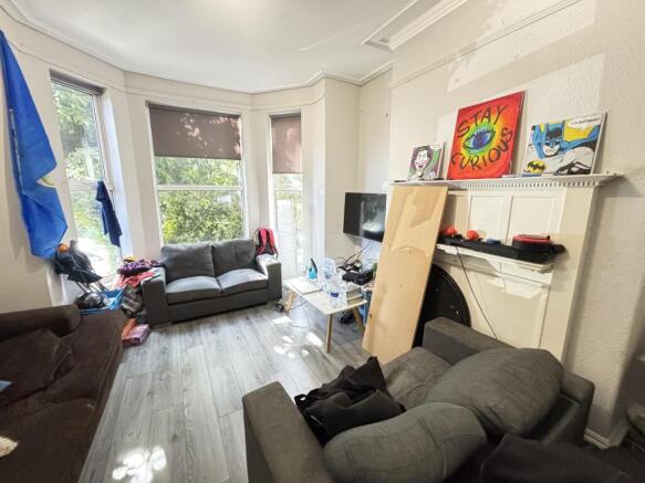 A bright and airy living room featuring large w...