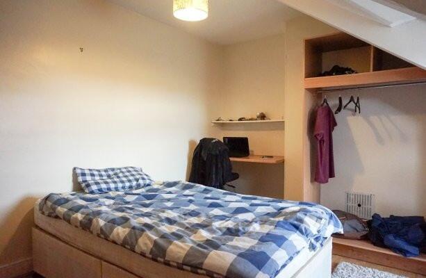 A cozy bedroom featuring a double bed with a st...