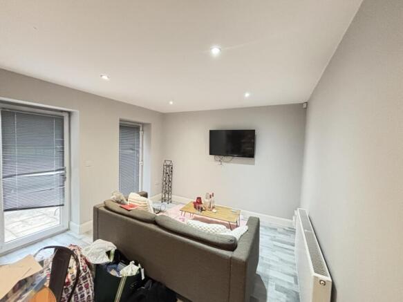 A modern, well-lit living room featuring a comf...