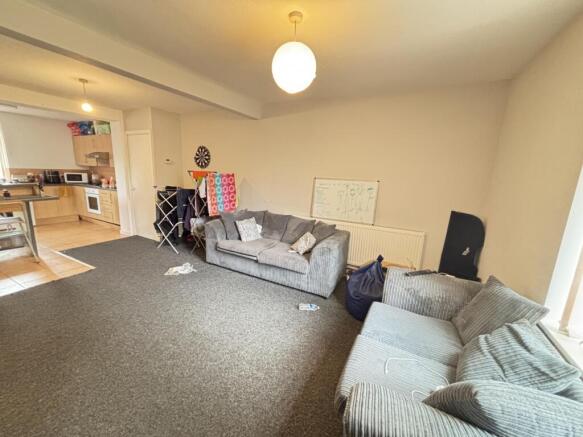 A spacious, well-lit living room featuring comf...