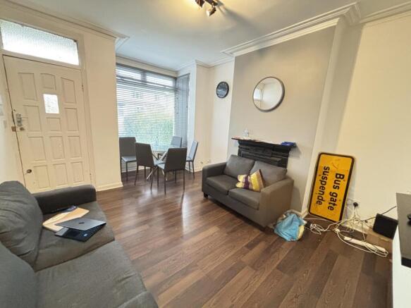 A well-lit and inviting living room with comfor...