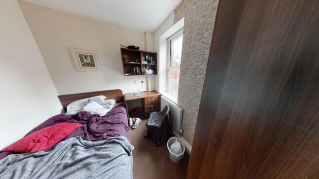 A cozy bedroom with natural light coming throug...