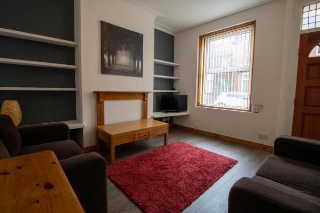 Comfortable living room with a wood-accent fire...