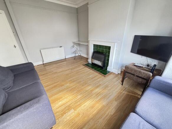 A bright and welcoming living room featuring a ...