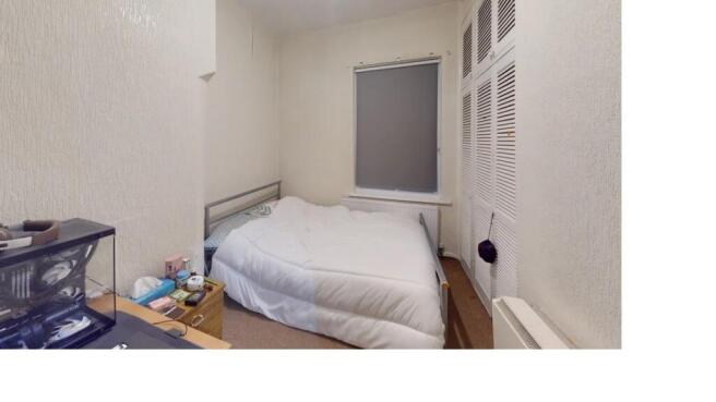 A cozy and well-maintained bedroom featuring a ...