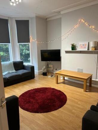 A bright, modern living room featuring large wi...