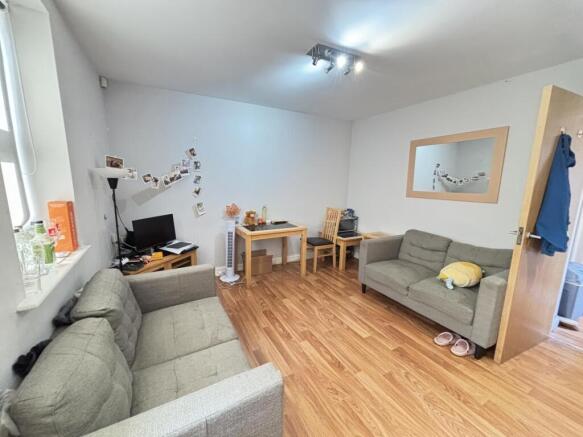 A spacious and bright modern living room featur...