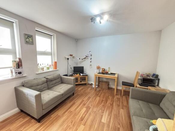 A bright and welcoming living room featuring co...