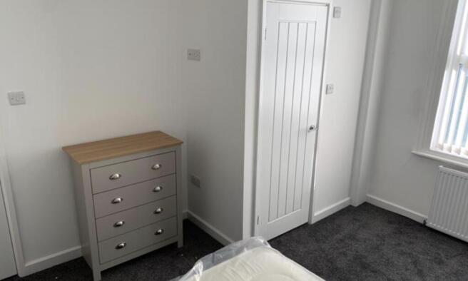 A well-maintained bedroom featuring a wardrobe ...