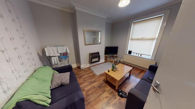 A bright and welcoming living room with ample n...