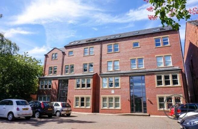 Well-maintained red-brick apartment building wi...