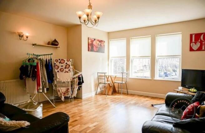 Bright, airy living room with large windows, wa...