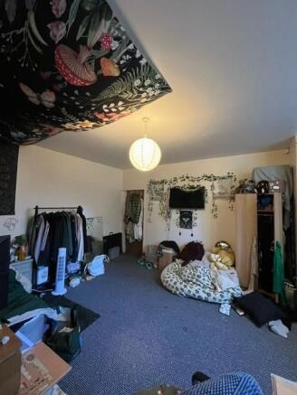 Spacious, well-decorated bedroom with a large o...