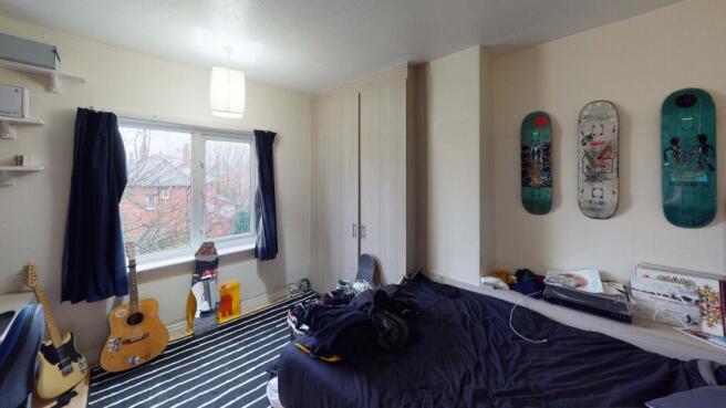 A cozy bedroom featuring a double bed, a large ...