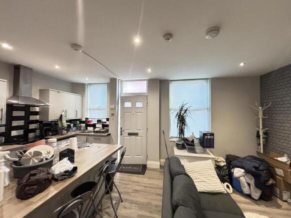 A spacious, modern living room with ample natur...