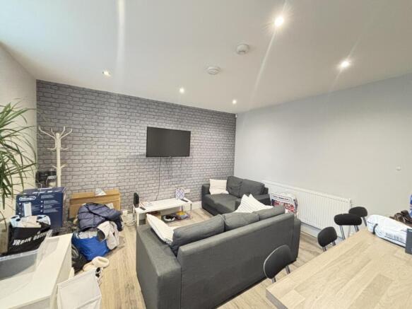 Spacious and well-lit modern living room featur...