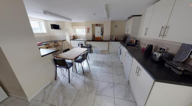 Modern kitchen featuring ample cabinetry and wo...