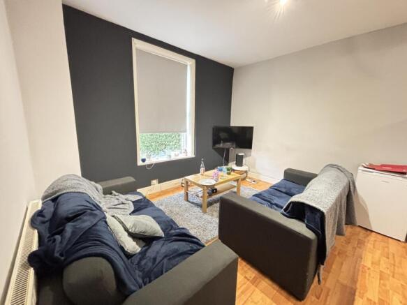 A modern and cozy living room with two sofas, a...