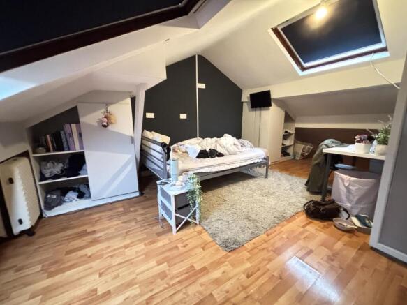 A cozy bedroom with a stylish bed frame, natura...