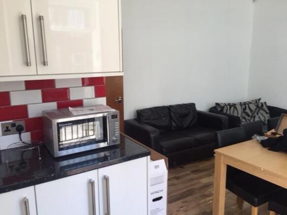 A spacious and modern living room featuring com...