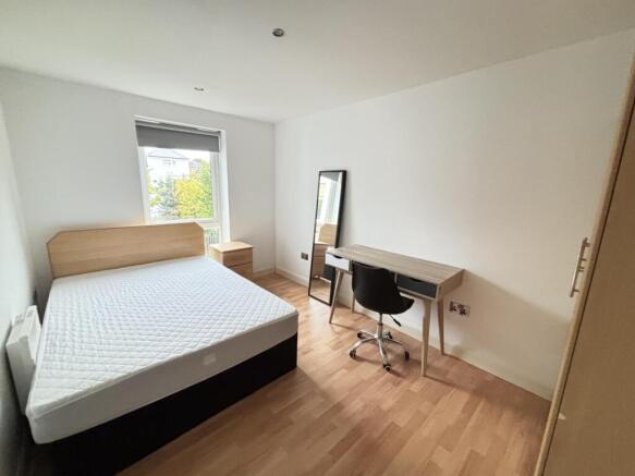 Bright and spacious master bedroom featuring a ...