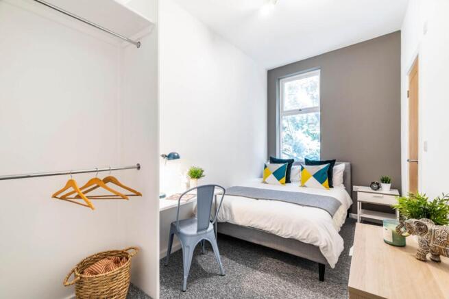 Bright and inviting master bedroom with a comfo...