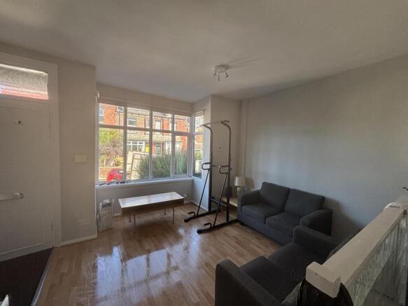 A bright and welcoming living room with large w...