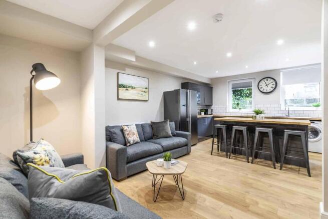 A modern, spacious living room with ample seati...