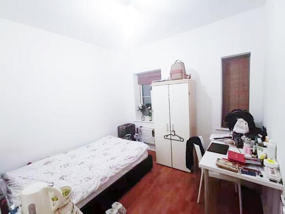 Bright, simply furnished single bedroom with a ...