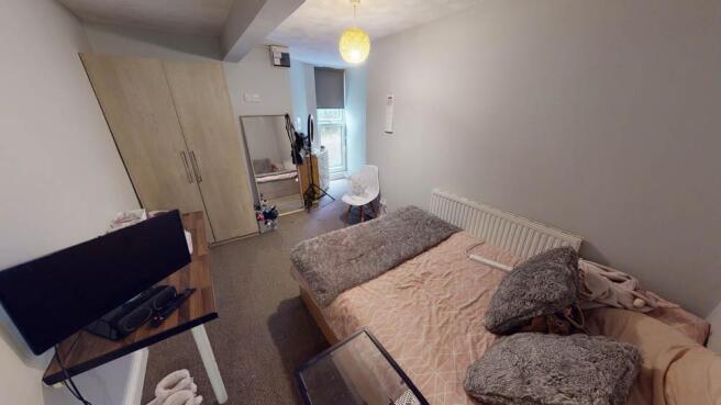 A modern living room with a comfortable sofa, a...