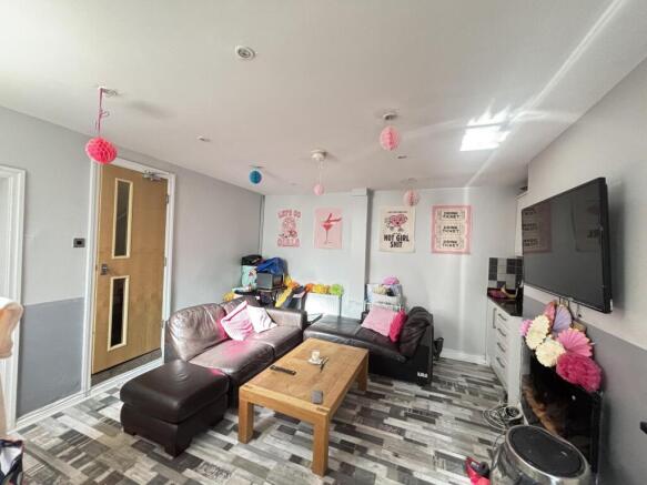 A bright and modern living room featuring a lar...