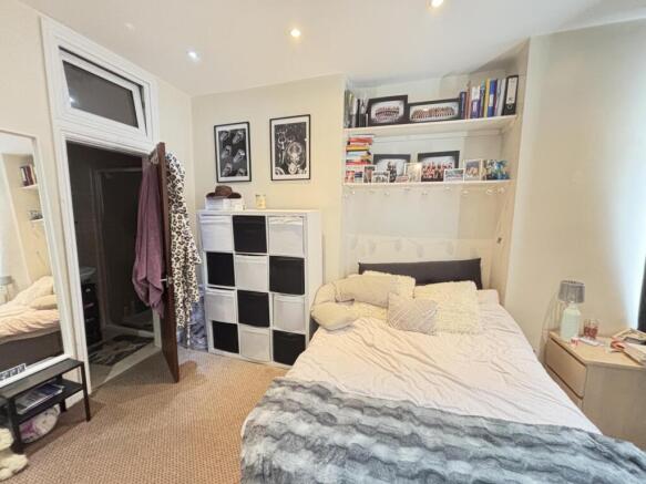 A bright and cozy bedroom featuring a comfortab...