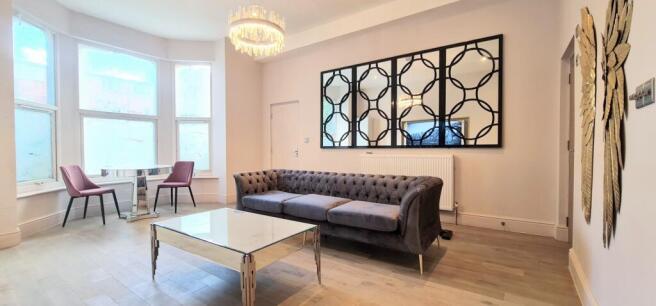 A bright and inviting living room featuring con...