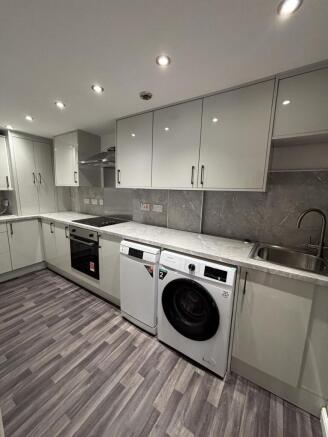 Modern, well-maintained kitchen featuring sleek...