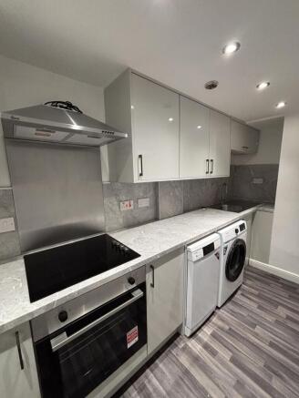 Modern kitchen featuring integrated appliances,...