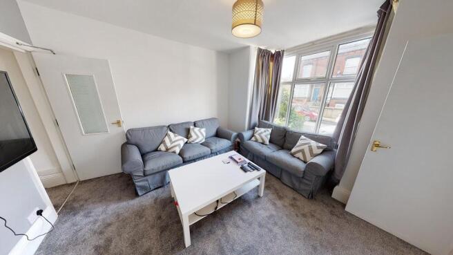 A bright and cozy living room with a comfortabl...