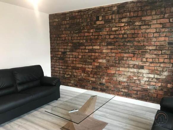 A modern, well-lit living room featuring a styl...