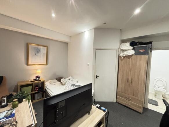 A cozy bedroom featuring a double bed, bedside ...