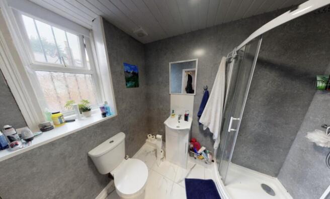 A clean, bright bathroom with a large bathtub a...