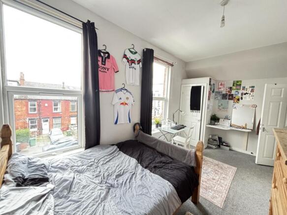 A cozy bedroom featuring a double bed with a pl...