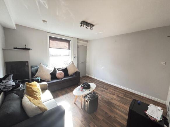 A bright and welcoming living room featuring a ...