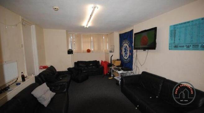 A spacious, modern living room with ample seati...